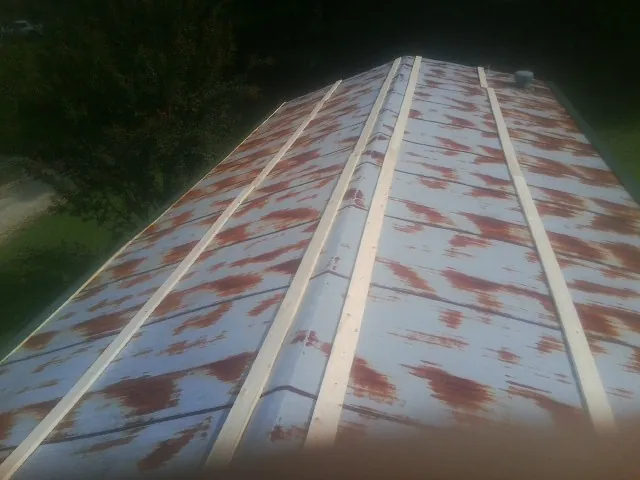 Rusted metal roof panels with new wood purlins before replacement — Storm Damage Roof Repair in Glenns Ferry by Roofing Brothers